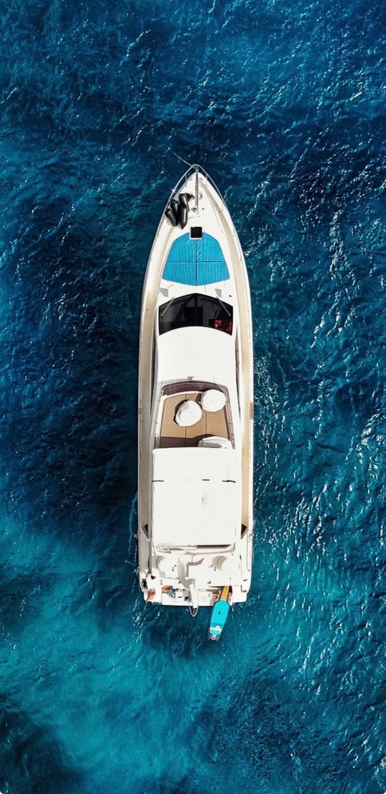 Overhead view of the white motor yacht on open ocean.