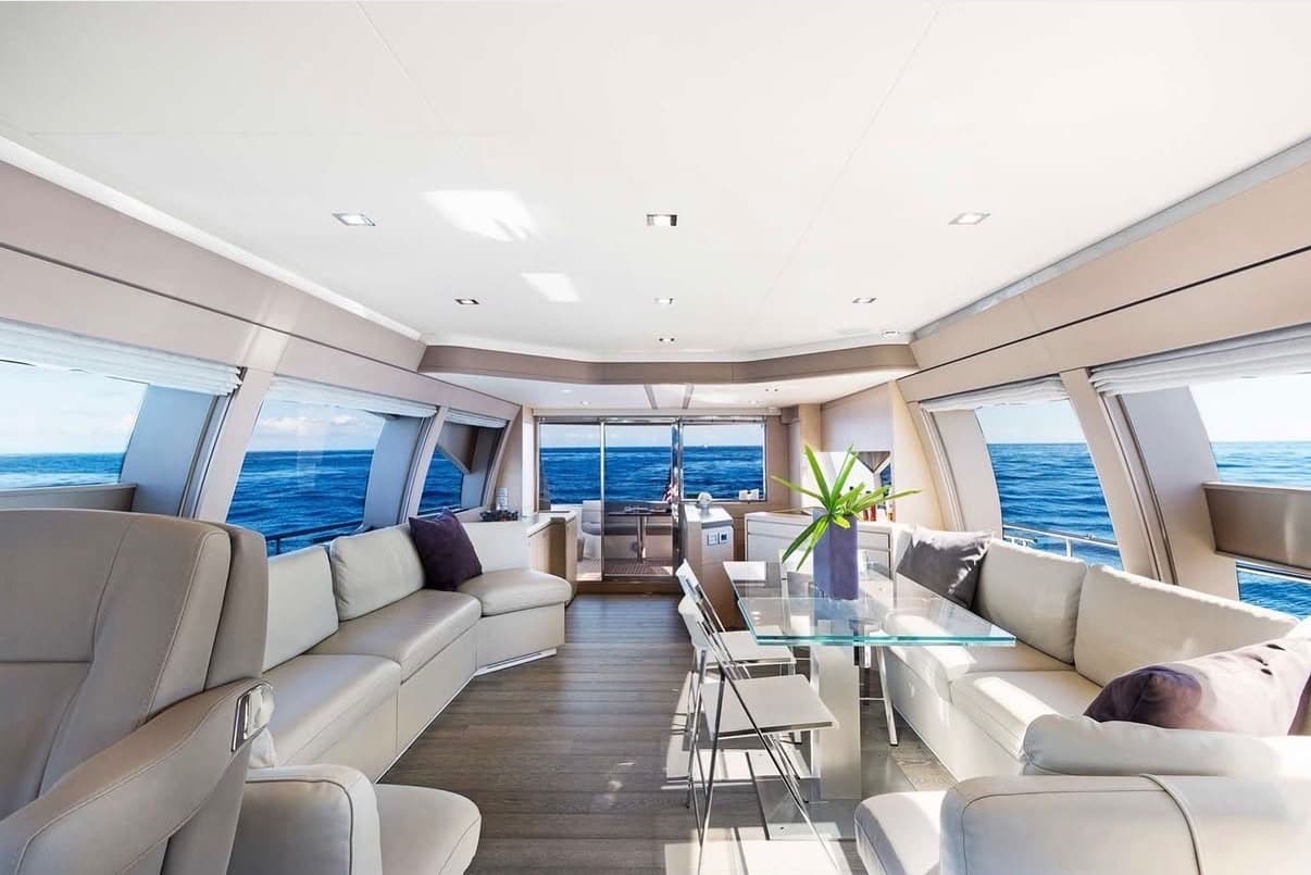 The bright main salon with cream leather seating and ocean views.