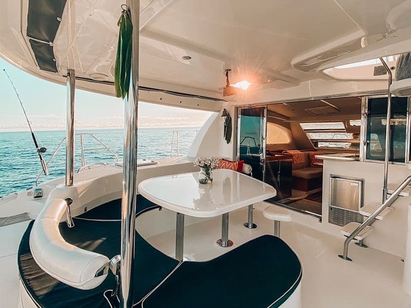 The aft cockpit table set against a glassy sunset.